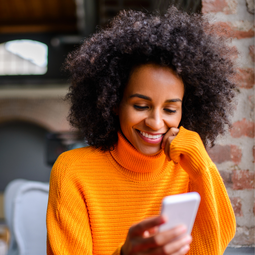 Woman looking a phone smiling